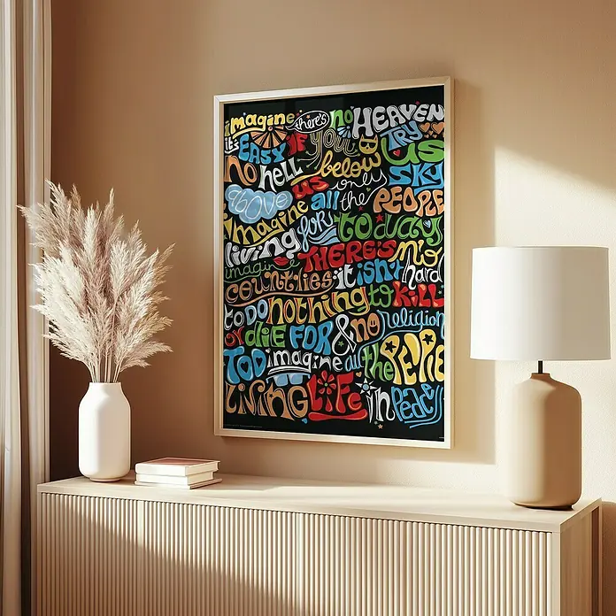 Papermoon Bild - Imagine, B x H: 40 x 50 cm, Ohne Passepartout, Rahmen Eiche - Ein gerahmtes, farbenfrohes Wandkunstwerk mit inspirierenden Wörtern und Botschaften hängt über einem stilvollen Sideboard mit Dekorationen.