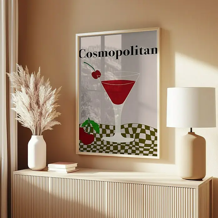 Papermoon Bild - Cosmopolitan, B x H: 70 x 100 cm, Mit Passepartout, Rahmen Eiche - Ein stilvolles Cosmopolitan-Poster, das in einem weißen Rahmen präsentiert wird und auf einer beigen Kommode mit einer Lampe und Deko steht.