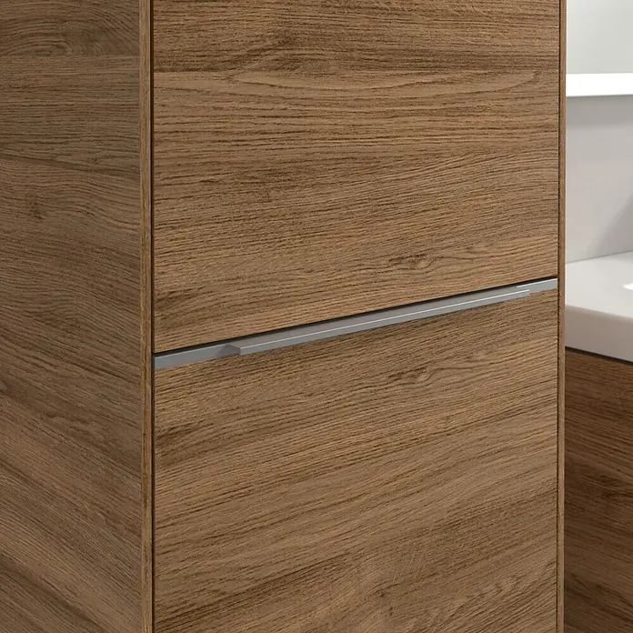 Villeroy & Boch Subway 3.0 Hochschrank - B x T x H: 40 x 36,2 x 171 cm, 1x Klappe mit Wäschekorb, 1x Tür, Kansas Oak, Farbe Griff: Aluminium glänzend, DIN Anschlag: Links - Nahaufnahme eines Badezimmerschranks mit Holzstruktur und einem schlichten, horizontalen Griff. Das Design ist modern und elegant.