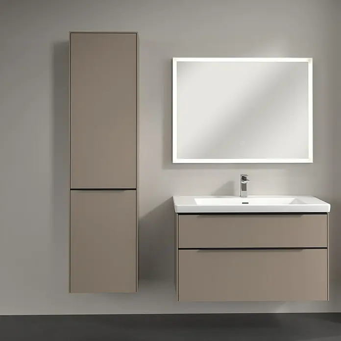 Villeroy & Boch Subway 3.0 Hochschrank - B x T x H: 40 x 36,2 x 171 cm, 1x Klappe mit Wäschekorb, 1x Tür, Taupe, Farbe Griff: Volcano black, DIN Anschlag: Links - Ein modernes Badezimmer-Ensemble mit einem Waschbeckenunterschrank, einem passenden Spiegelschrank und einem Hochschrank in Taupe.