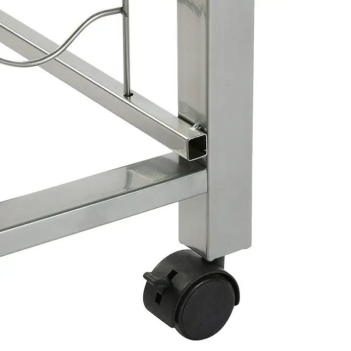 Versa Carro de cocina - L x An x Al: 40 x 40 x 82 cm, Blanco - Primer plano de un carro de servicio metálico con una rueda negra. El diseño robusto y las ruedas prácticas facilitan el transporte.