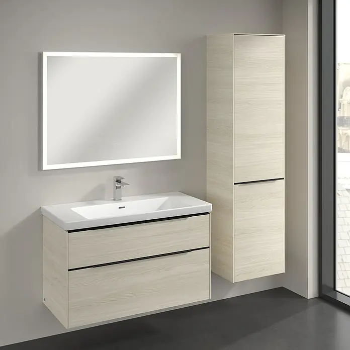 Villeroy & Boch Subway 3.0 Hochschrank - B x T x H: 40 x 36,2 x 171 cm, 1x Klappe mit Wäschekorb, 1x Tür, White Oak, Farbe Griff: Volcano black, DIN Anschlag: Rechts - Ein modernes Badezimmer-Set mit einem beleuchteten Spiegel, einem Waschtisch mit Schubladen und einem Hochschrank in Holzoptik.