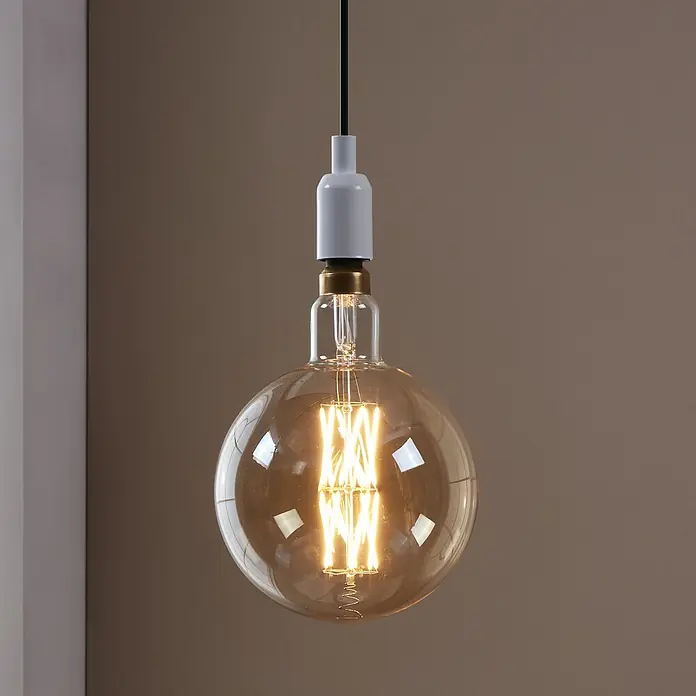 Eglo LED-Lampe - E27, Dimmbar, Warmweiß, 806 lm, 8 W - Nahaufnahme einer runden Edison-Glühbirne mit Glühfäden, die von einer weißen Fassung gehalten wird, und einem schwarzen Kabel.
