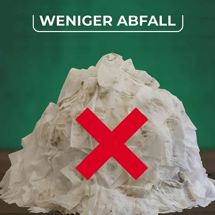 Vileda Bodenwischer Spray & Clean Sprühwischer - 2 -tlg. - Weniger Abfall: Ein Berg von benutzten Papiertüchern ist mit einem roten "X" versehen, um die Notwendigkeit der Abfallreduzierung zu betonen.