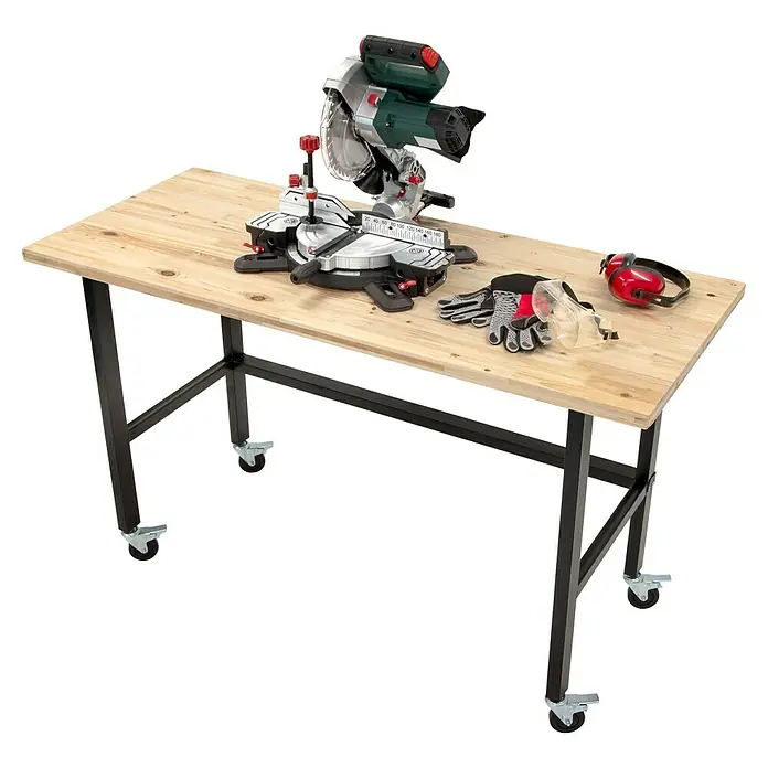 Rikta Werkbank mit Rollen - L x B: 140 x 60 cm, Arbeitshöhe: 84 cm, Belastbarkeit: 200 kg - Eine Tischkreissäge, Handschuhe, Schutzbrille und Kopfhörer liegen auf einem Holztisch mit Metallbeinen und Rollen.