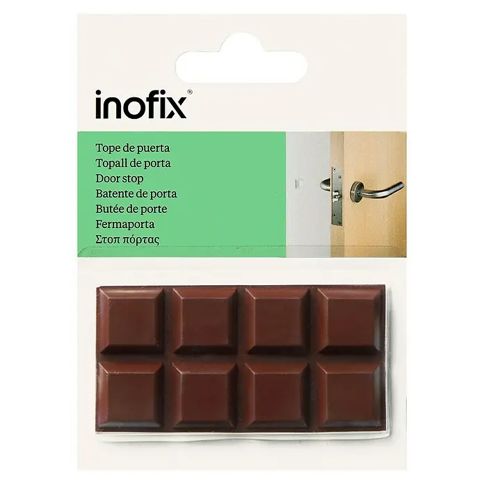 Inofix Tope de puerta 2090 - Plástico, Marrón - Embalaje de un tope de puerta Inofix con etiquetado multilingüe y una tableta de chocolate debajo.