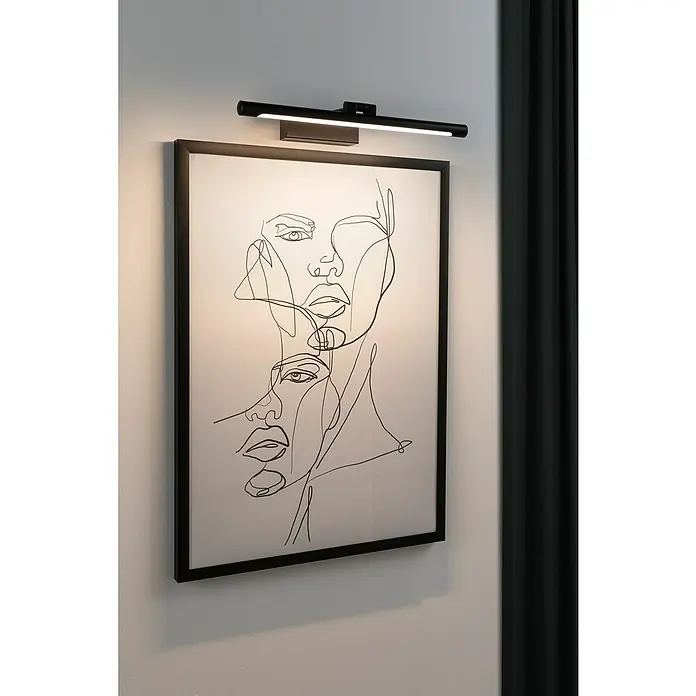 Paulmann LED-Bilderleuchte Mingo - 11 W, L x B x H: 17,5 x 41,5 x 5 cm, Schwarz, Warmweiß - Wandmontierte Bilderleuchte in Schwarz über einem gerahmten Bild mit abstrakter Strichzeichnung von zwei Gesichtern, die ein minimalistisches Ambiente erzeugt.
