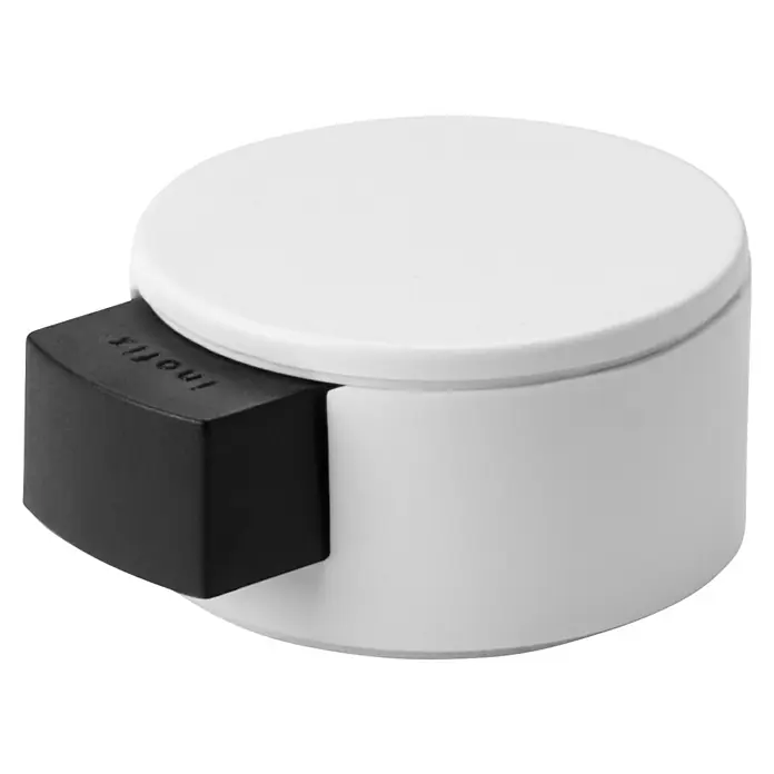 Inofix Tope de puerta 2420 - Plástico, Blanco - Primer plano de un tope de puerta blanco con un protector de goma negro en el lateral para mayor estabilidad y protección.
