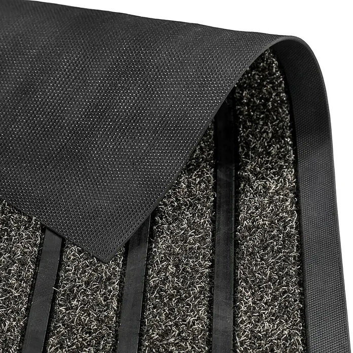 Astra Fußmatte Scraper Line - Anthrazit/Schwarz, 40 x 60 cm - Nahaufnahme einer schwarzen Fußmatte mit einem Muster aus erhabenen Linien und einer rutschfesten Unterseite für zusätzlichen Halt.