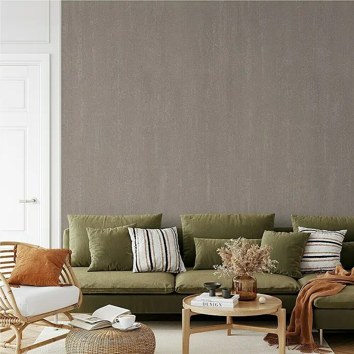 Papel pintado Texturado - Gris, Unicolor, 10 x 0,53 m - Un salón acogedor con un sofá verde, cojines decorativos y una mesa redonda con elementos decorativos.