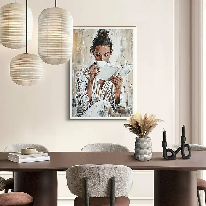 Reinders Bild Slim Frame - Morning Reading, B x H: 50 x 70 cm - Elegantes Esszimmer mit einem Wandbild, das eine Frau beim Lesen und Kaffeetrinken zeigt. Die Pendelleuchten verleihen dem Raum eine warme Atmosphäre.