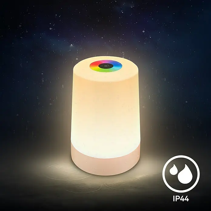 Brilo Akku-Tischleuchte Nubsi - Ø x H: 9 x 13 cm, Beige, RGBW, 2,8 W, IP44 - Nahaufnahme einer RGB-LED-Tischleuchte mit Touch-Steuerung und IP44-Schutzklasse, die ein sanftes, stimmungsvolles Licht in dunkler Umgebung ausstrahlt.