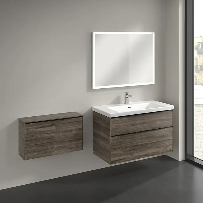 Villeroy & Boch Subway 3.0 Seitenschrank - B x T x H: 72,8 x 25,6 x 42,3 cm, Stone Oak, DIN Anschlag: Links/Rechts, Farbe Griff: Volcano Black - Ein modernes Badezimmer-Ensemble mit einem Unterschrank mit Waschbecken, einem Hängeschrank und einem beleuchteten Spiegel, die zusammen ein stilvolles Ambiente schaffen.