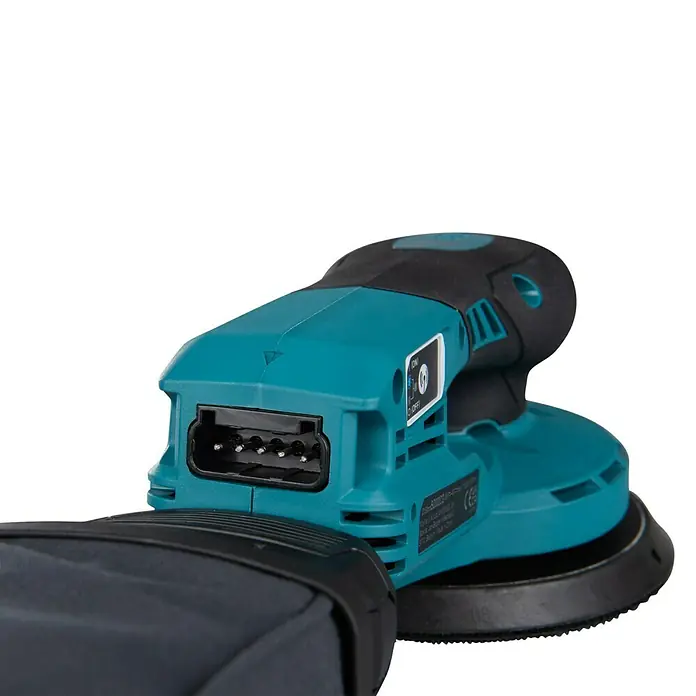 Makita XGT 40V max. Akku-Exzenterschleifer BO002CGZ - 40 V, Ohne Akku, Durchmesser Schleifteller: 150 mm - Nahaufnahme eines türkisfarbenen Exzenterschleifers mit schwarzem Griff und Staubabsaugung.