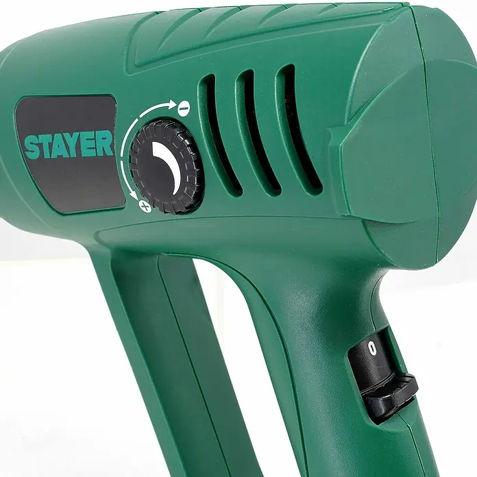 Stayer Pistola de aire caliente SUH2000EK - 2.000 W, 50 °C - 600 °C - Primer plano de una pistola de calor Stayer verde, que muestra el control de temperatura y el interruptor de encendido/apagado.
