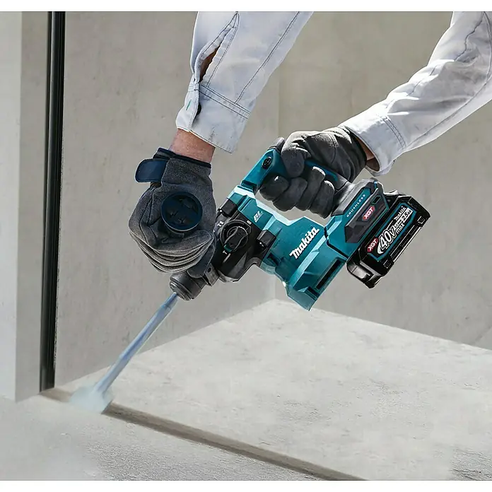 Makita XGT 40V max. Akku-Kombihammer HR010GZ - 40 V, Ohne Akku, 2,1 J - Nahaufnahme eines Makita Akku-Bohrhammers in Aktion, der in Beton arbeitet. Ideal für Bau- und Renovierungsprojekte.