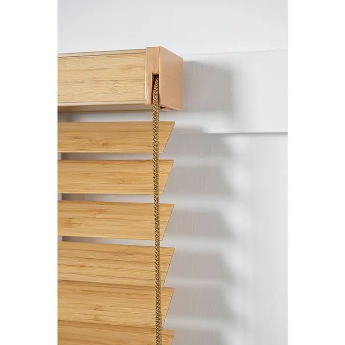 Veneciana Bambú - An x Al: 120 x 160 cm, Roble, Madera - Primer plano de persianas de bambú con cordón. Las persianas de madera son de color marrón claro y cuelgan delante de una pared blanca.