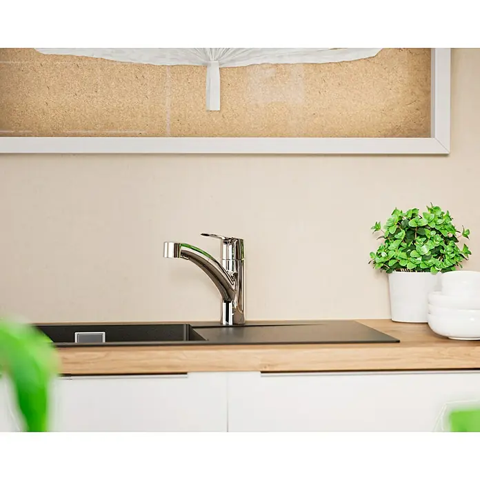 Grohe QuickFix Spültischarmatur Start - Chrom, Ausziehbar, Glänzend - Eine elegante Küchenarmatur aus Chrom auf einer modernen Arbeitsplatte mit Spüle und grüner Pflanze als Dekoration.