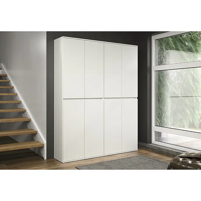 Trendteam Hochschrank Nevada - B x T x H: 148 x 34 x 191 cm, Weiß - Ein großer weißer Kleiderschrank mit minimalistischem Design steht neben einer Treppe und einem Fenster. Praktische Möbel zur Aufbewahrung.