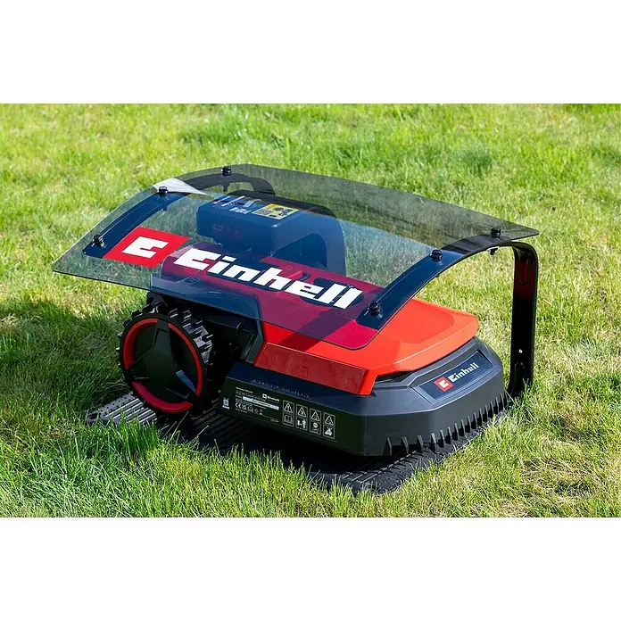 Einhell Mähroboter-Garage - L x B x H: 51 x 60 x 37 cm, Einhell Freelexo Mähroboter - Ein roter Einhell Mähroboter steht auf einem grünen Rasen. Er hat eine transparente Abdeckung und schwarze Räder.