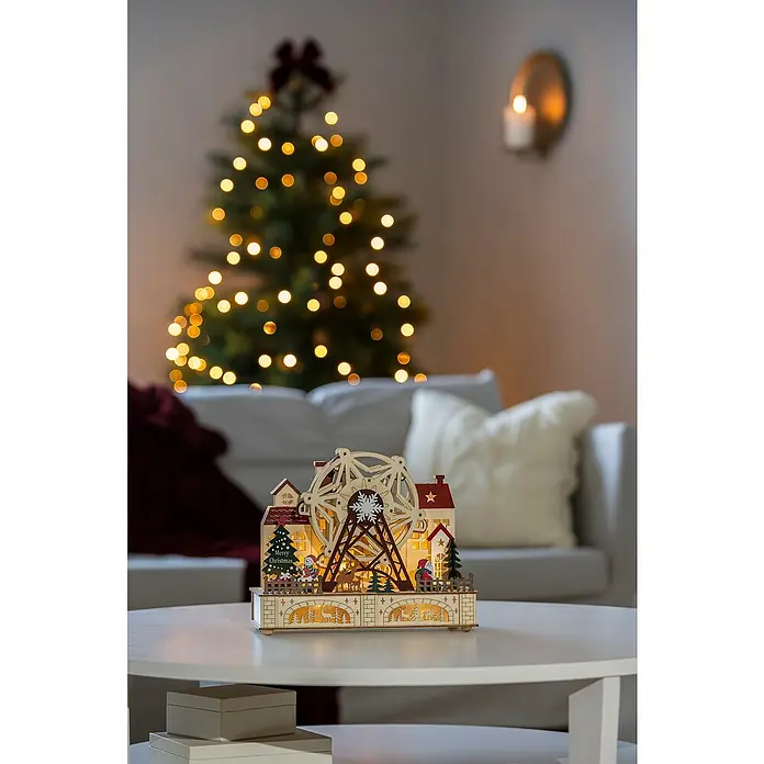 Konstsmide LED-Szenerie Weihnachtsmarkt - L x B x H: 28 x 12 x 24,5 cm, Weiß, Batteriebetrieben, LED - Weihnachtsdekoration mit beleuchtetem Holz-Riesenrad vor einem festlichen Hintergrund.