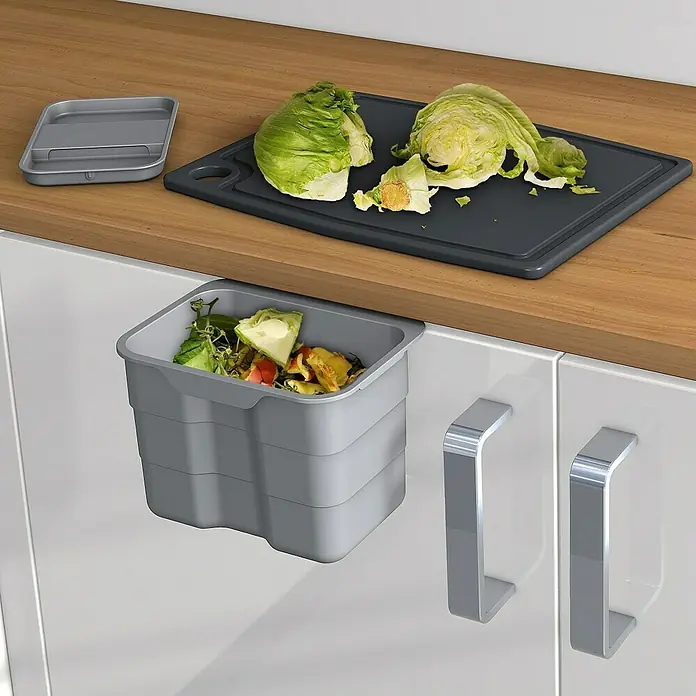 essensa Einbaumülleimer Biobin Aufbewahrungsbox - 4,2 l, Kunststoff, Hellgrau - Küchenbild mit einem grauen Abfallbehälter, einer Schneidebrett mit Salat und einem Behälterdeckel auf einer Arbeitsplatte.