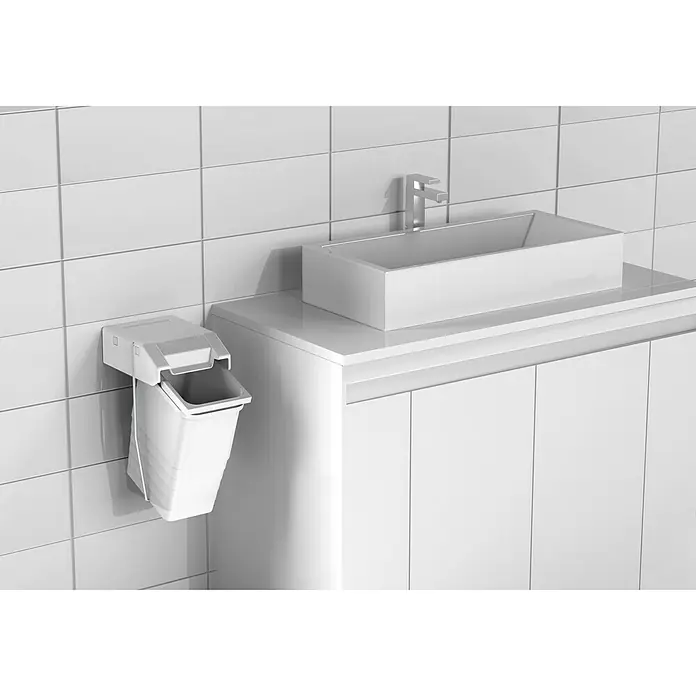 essensa Standard-Mülleimer Single - 8 l, Kunststoff, Weiß - Wandmontierter, weißer Mülleimer neben einem Waschbecken und einem Unterschrank im Badezimmer mit weißen Fliesen.