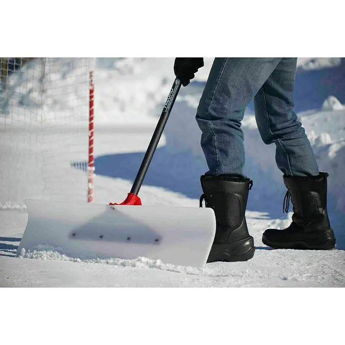 Freund Victoria Schneeschieber Dachräumer - Breite: 60 cm, Teleskopstiel - Schneeschieber im Einsatz. Die Schneeschaufel mit dem roten Griff ist auf Schnee zu sehen und wird von einer Person bedient.