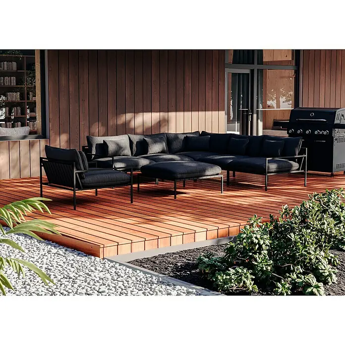 Sunfun Loungemöbel-Set - 7 -tlg., Aluminium, Textil, Night Grey/Schwarz - Luxuriöse Outdoor-Lounge mit dunklen Polstermöbeln und Grill auf einer Holzterrasse, umgeben von Kies und Grünpflanzen. Perfekt für stilvolle Entspannung.