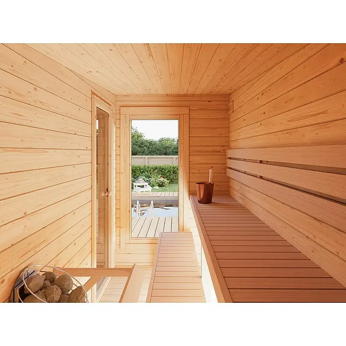 Palmako Saunahaus Sanna - Ohne Ofen, Natur, L x B x H: 329 x 564 x 239 cm - Innenansicht einer Sauna mit Holzbänken, Steinen und Blick nach draußen, die Wärme und Entspannung verspricht.