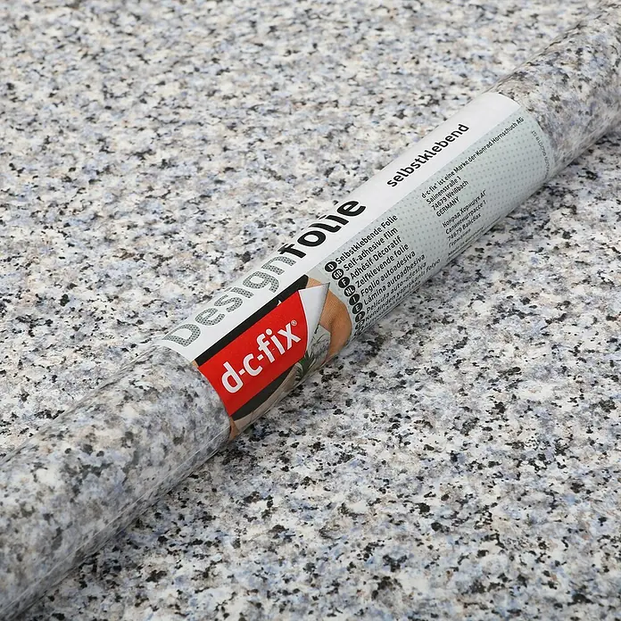 D-c-fix Porrinho-Effektfolie - 200 x 45 cm, Grau-Blau, Selbstklebend - Nahaufnahme einer Rolle selbstklebender Designfolie von d-c-fix mit Granit-Muster, ideal für die Dekoration von Möbeln und Oberflächen.