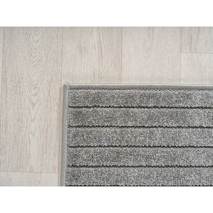 Outdoor-Teppich Nova I - Silver, Durchmesser: 80 cm, 100 % Polypropylen - Nahaufnahme eines grauen Teppichs mit Streifenmuster auf einem hellen Holzboden, der eine gemütliche Atmosphäre schafft.