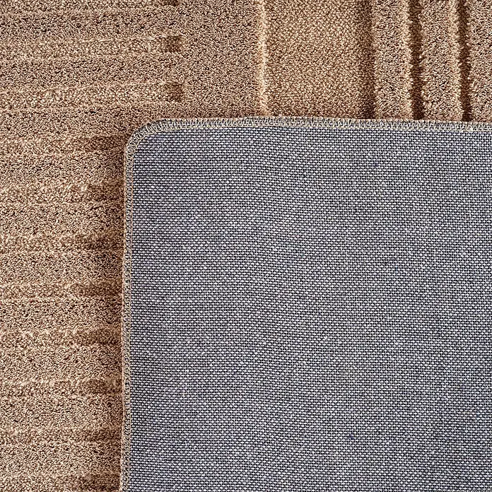Kurzflorteppich Pompei 1612 - Beige, 290 x 200 cm, 100 % Polyester - Detailaufnahme einer beigen Fußmatte mit blauem, gewebtem Rücken, die Langlebigkeit und Rutschfestigkeit verspricht. Perfekt für jeden Eingangsbereich.