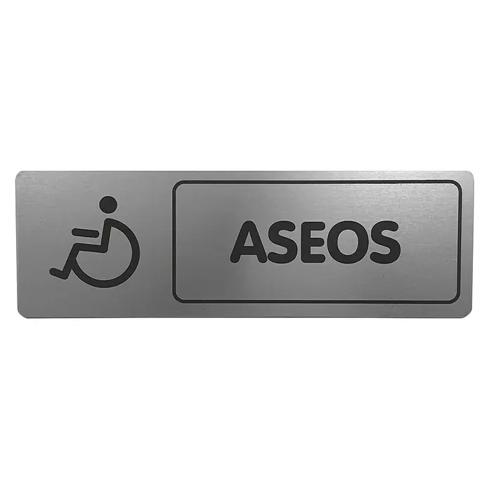 Rótulo - Plateado/Negro, Aseo para minusválidos, 18 x 5 cm - Aquí hay un letrero para baños accesibles, con el texto "ASEOS" y un símbolo de silla de ruedas. El letrero está hecho de metal y tiene letras claras.