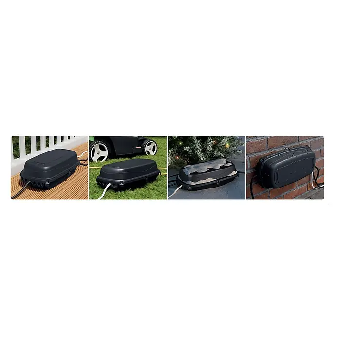 D-Line Kabelbox Save Box - Schwarz, L x B x H: 36 x 19,5 x 11,5 cm - Das Bild zeigt eine wetterfeste Steckdosenbox, die auf verschiedenen Oberflächen wie Holz, Gras und Ziegeln platziert ist.