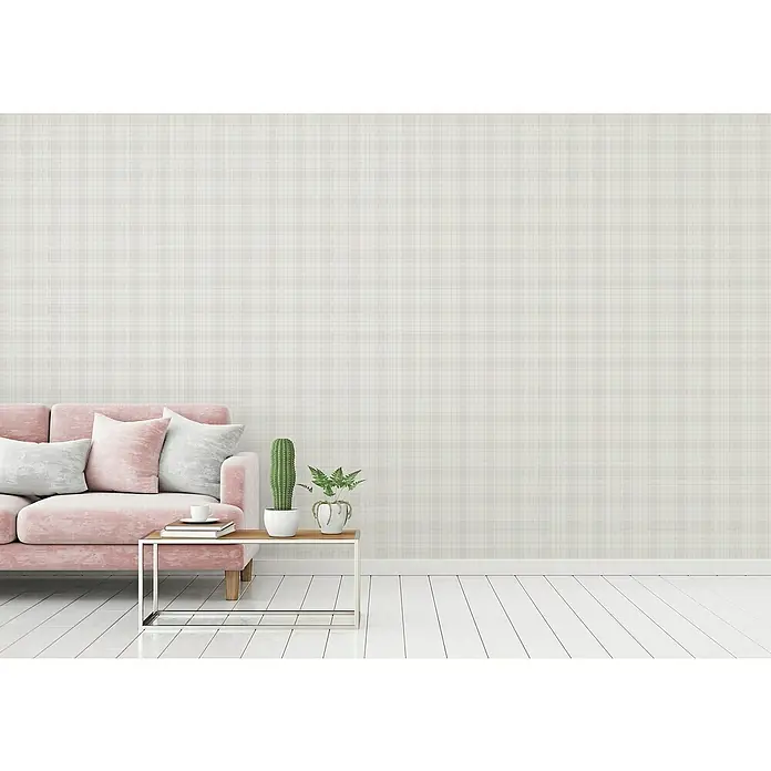 A.S. Création Maison Charme Vliestapete Karo - Grün-Grau-Weiß, Grafisch, 10,05 x 0,53 m - Nahaufnahme eines Wohnzimmers mit einem rosa Sofa, einem Beistelltisch mit Pflanzen und einer karierten Tapete.