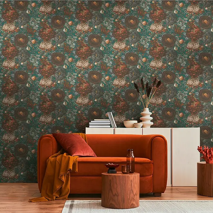 A.S. Création Michalsky Metropolis Vliestapete Blüten - Grün-Grau-Orange, Floral, 10,05 x 0,53 m - Stilvolles Wohnzimmer mit einem auffälligen orangefarbenen Sofa, einem eleganten Sideboard und einer floralen Tapete.