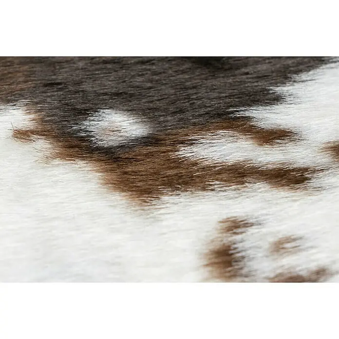 Kunstfell Rodeo - Braun/Weiß, 200 x 150 cm, 100 % Polyester, Kuh - Nahaufnahme einer Kuhfell-Textur in Weiß und Braun, ideal für Textil- oder Hintergrunddesign.