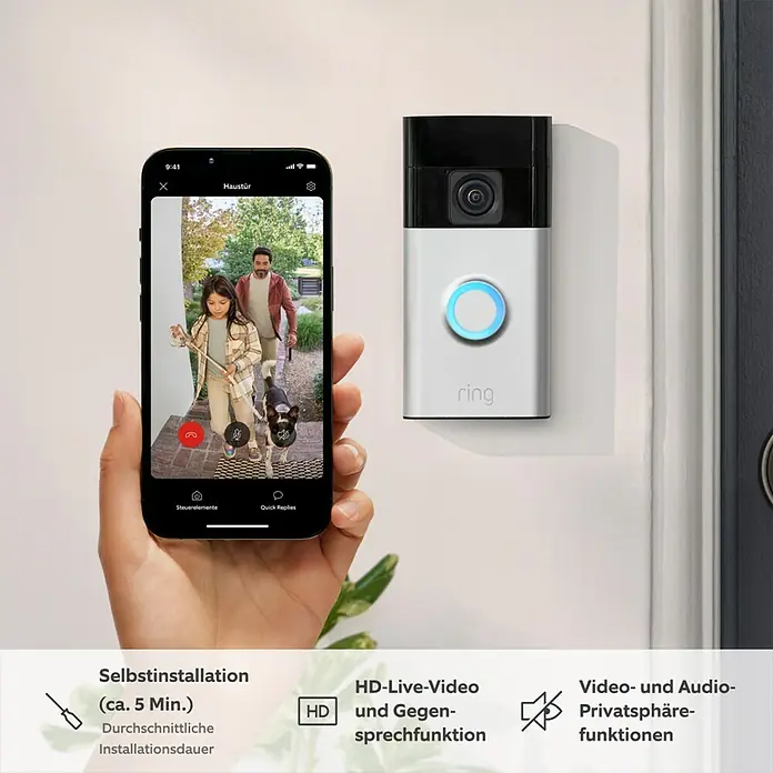 Ring Set Türklingel mit Kamera Video Doorbell Akku + Chime Akku (2nd Gen) - Nickel, 2.560 x 1.440 Pixel, 2,3 x 6,19 x 12,65 cm - Nahaufnahme einer Ring-Türklingel mit einer Person, die durch eine Smartphone-App angezeigt wird.