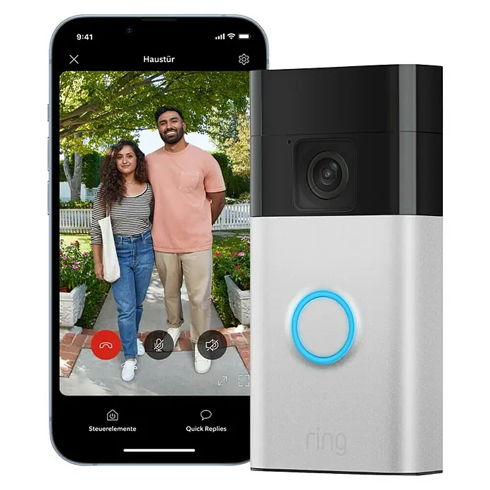 Ring Set Türklingel mit Kamera Video Doorbell Akku + Chime Akku (2nd Gen) - Nickel, 2.560 x 1.440 Pixel, 2,3 x 6,19 x 12,65 cm - Das Bild zeigt eine Ring-Videotürklingel neben einem Smartphone mit einer Live-Ansicht von zwei Personen vor einer Haustür.