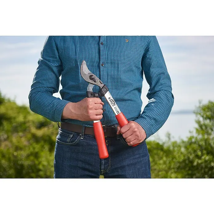 Felco Astschere 211-40 - Max. Aststärke: 35 mm, Länge: 40,5 cm - Der Mann hält eine Felco Baumscheren mit roten Griffen in der Hand, ideal für den professionellen Baumschnitt und die Gartenarbeit.