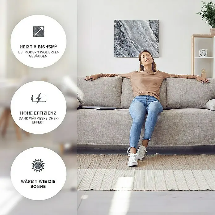 Marwona Infrarotheizkörper Infrarotheizung - B x H: 50 x 60 cm, 500 W, Qarama 500 Watt - Eine entspannte Frau sitzt auf einem Sofa vor einem Infrarot-Heizpaneel, das für moderne, isolierte Gebäude geeignet ist und bis zu 15 m² heizt.