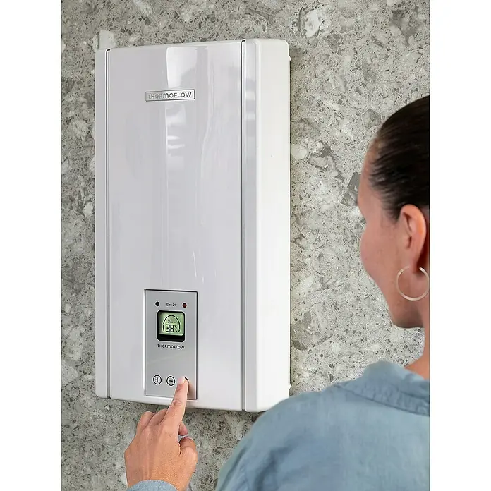 Thermoflow Durchlauferhitzer Elex 21N - 21 kW, Elektronisch, Geschlossen - Frau stellt Temperatur am Thermoflow Warmwasserbereiter ein.