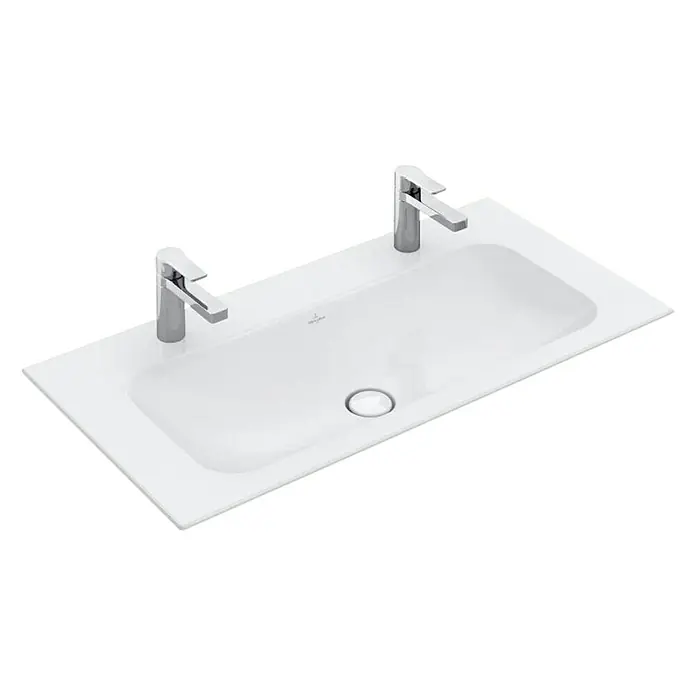 Villeroy & Boch Finion Einbauwaschbecken - 100 x 50 cm, Mit schmutzabweisender Glasur, Hahnloch: Mitte, Anzahl Hahnlöcher: 2, Weiß - Das Bild zeigt ein stilvolles Aufsatzwaschbecken mit zwei Armaturen, das durch sein modernes Design besticht. Ideal für ein elegantes Badezimmer.