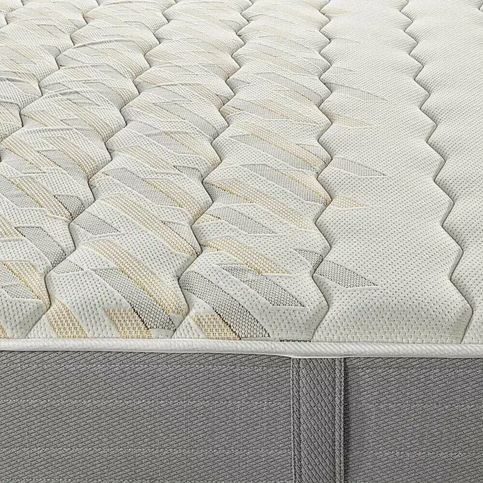 Espacio Descanso Colchón - Largo: 190 cm, Ancho: 90 cm, Altura: 24 cm, Espuma HR y Viscoelástica, Colchón a 2 caras - Primer plano de un colchón con un patrón de formas geométricas y líneas horizontales en tonos blancos, beige y gris.