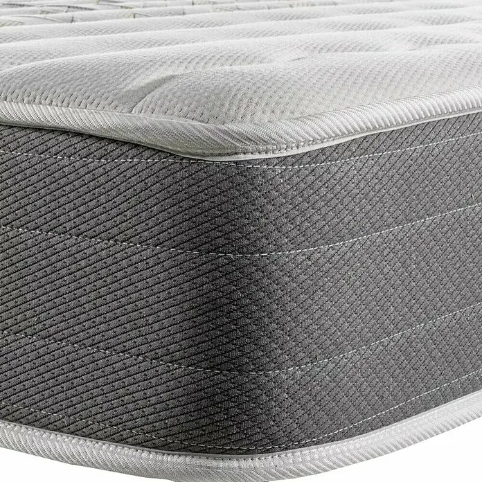 Espacio Descanso Colchón - Largo: 190 cm, Ancho: 90 cm, Altura: 24 cm, Espuma HR y Viscoelástica, Colchón a 2 caras - Primer plano de un colchón con una funda gris y un borde blanco. El colchón está acolchado y parece muy cómodo.