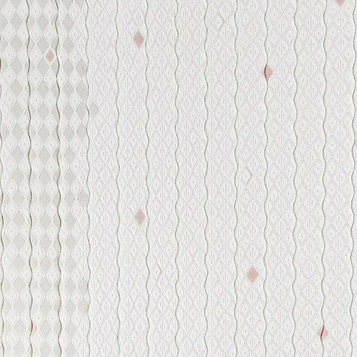 Espacio Descanso Colchón - Largo: 190 cm, Ancho: 135 cm, Altura: 22 cm, Espuma HR y Viscoelástica, Colchón a 2 caras - Primer plano de un colchón con funda blanca y un patrón de rombos, acentuado por pequeños detalles rojos.