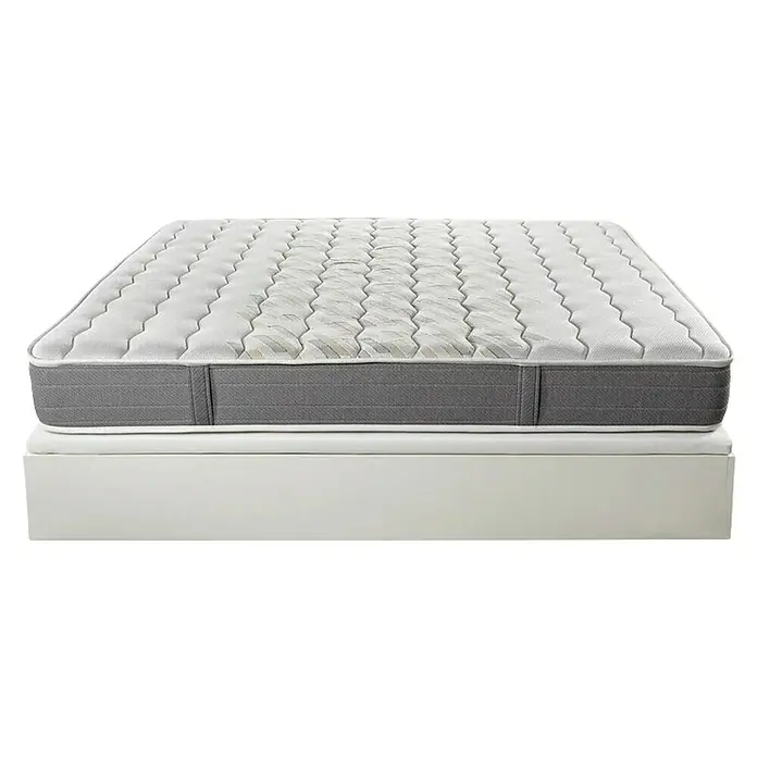 Espacio Descanso Canapé y colchón - L x An x Al: 190 x 90 x 56 cm, Blanco, Abatible, Espuma HR y Viscoelástica - Primer plano de un colchón de alta calidad con una parte superior acolchada y un borde gris sobre una estructura de cama.