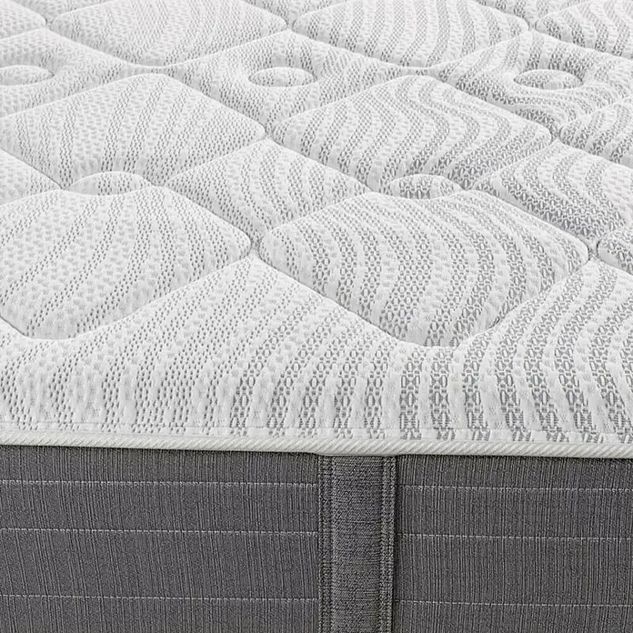 Espacio Descanso Colchón - Largo: 190 cm, Ancho: 90 cm, Altura: 26 cm, Muelles ensacados y Viscoelástica - Primer plano de un colchón cómodo con una superficie acolchada y un borde gris.