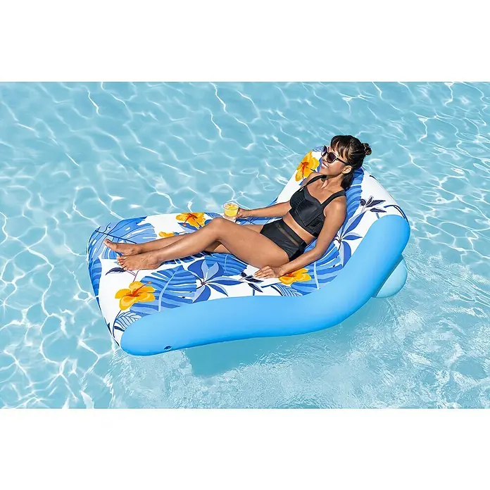 Bestway Luftmatratze Blissfull Drifter - Länge: 155 cm, Breite: 96 cm - Frau entspannt auf einer aufblasbaren tropischen Poolliege im Wasser, mit Getränk in der Hand.
